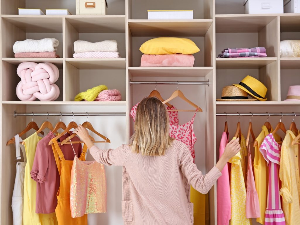 image-of-blonde-lady-in-pink-organising-her-wardrobe