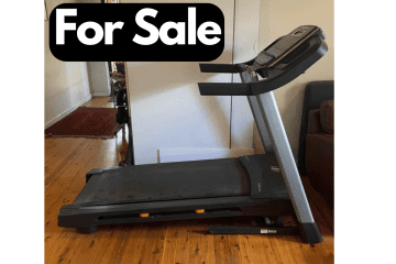 Image of Treadmill in living room with a For Sale sign